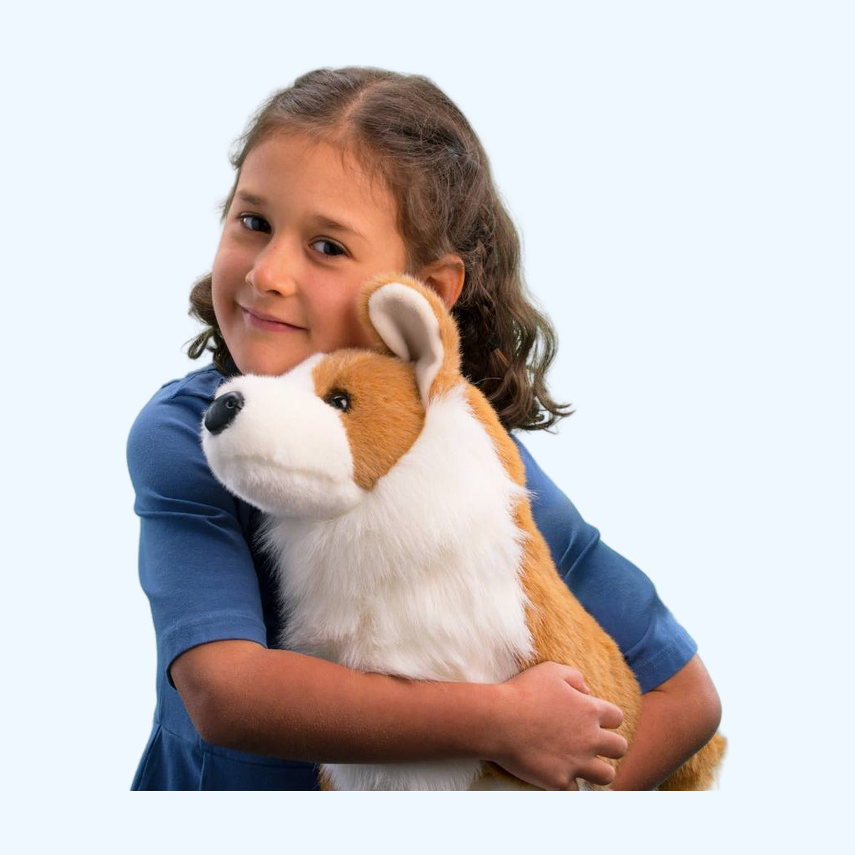 Child hugging the Douglas Essa Chadwick Corgi plush, showing his Medium cuddle size