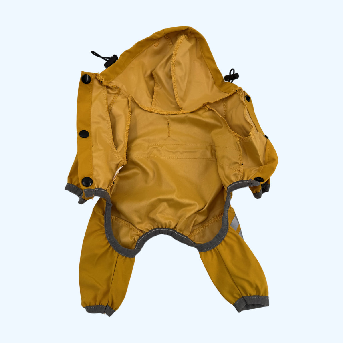 Yellow ESSA Raincoat opened flat showing the inner lining and press studs