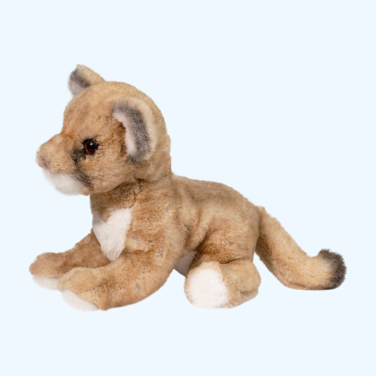 Side profile of Carmie Soft Mountain Lion plush resting, with floppy legs and long tail