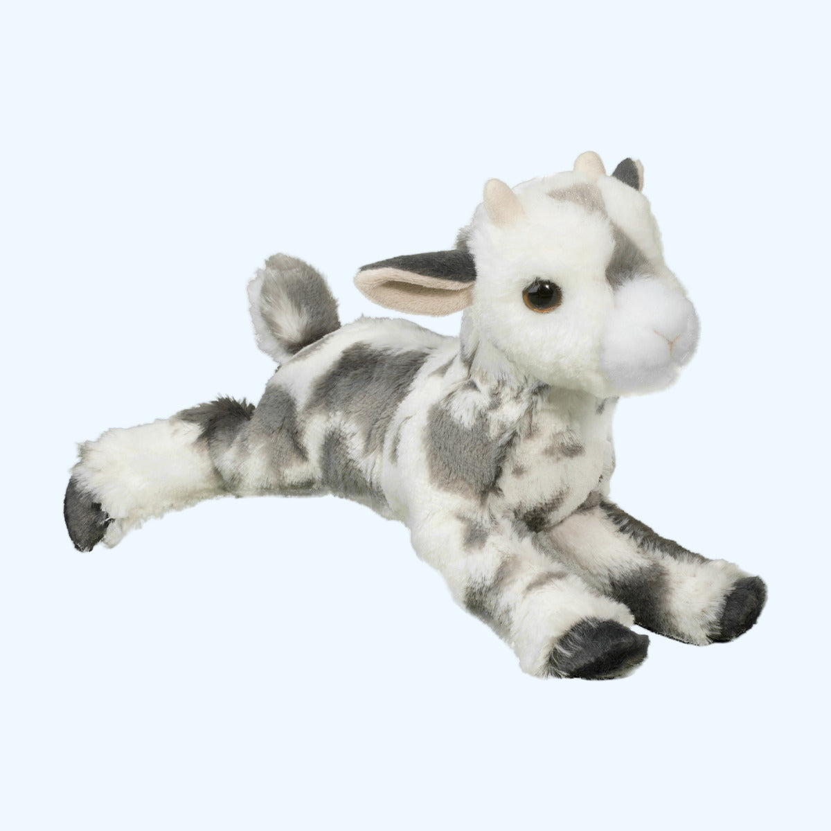 Douglas Essa Poppy Goat plush lying with legs stretched out, grey spotted creamy coat